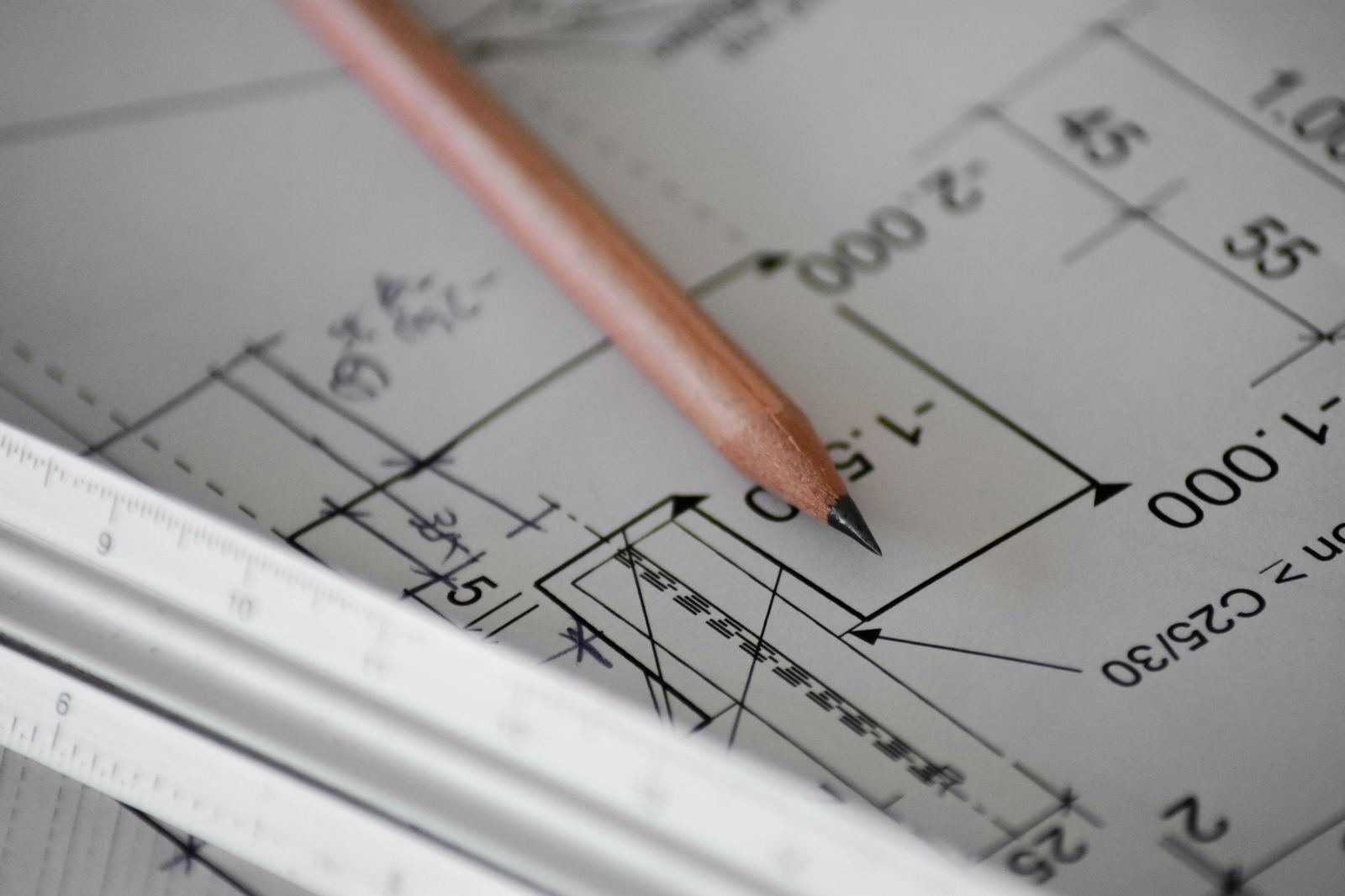Pencil and ruler on a technical blueprint drawing